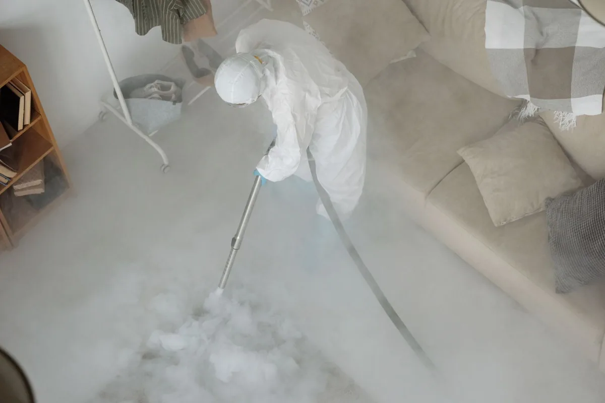 Biohazard cleanup technician in protective equipment, Garden Court, Philadelphia, PA